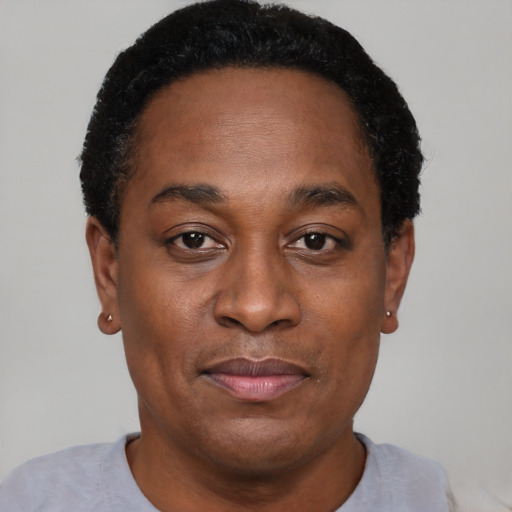 Joyful black adult male with short  black hair and brown eyes