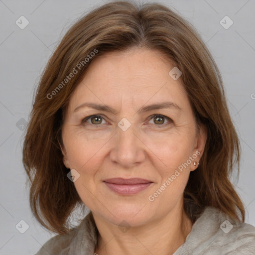 Joyful white adult female with medium  brown hair and brown eyes