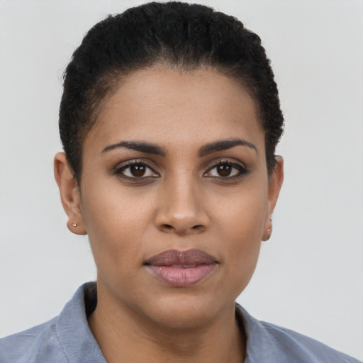 Joyful latino young-adult female with short  brown hair and brown eyes
