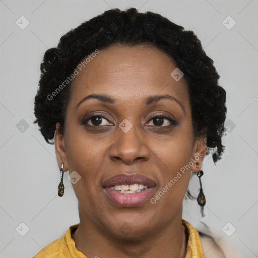 Joyful black adult female with short  brown hair and brown eyes