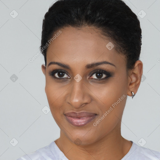 Joyful black young-adult female with short  black hair and brown eyes