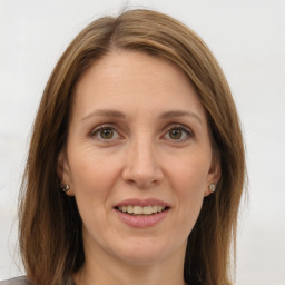 Joyful white adult female with long  brown hair and brown eyes