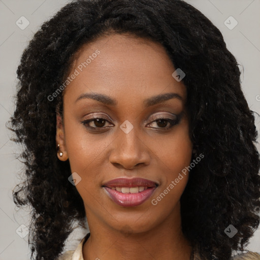 Joyful black young-adult female with long  black hair and brown eyes