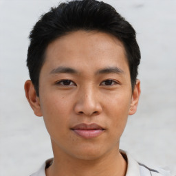 Joyful asian young-adult male with short  brown hair and brown eyes