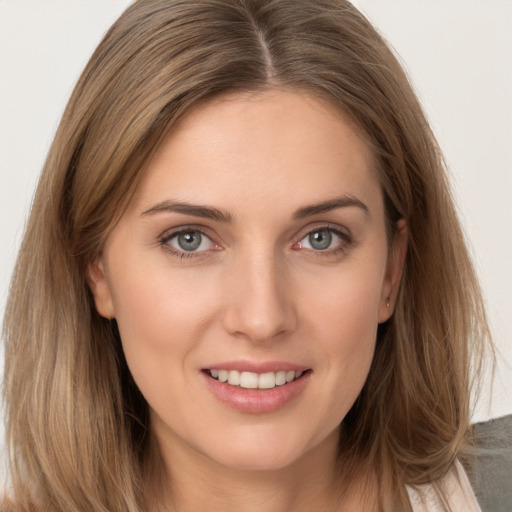 Joyful white young-adult female with long  brown hair and grey eyes