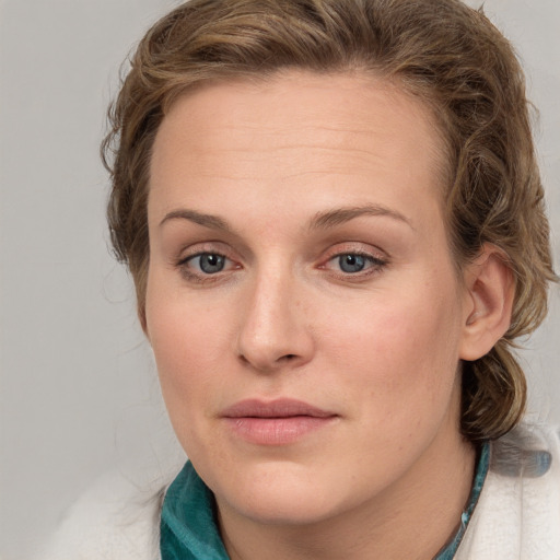 Joyful white young-adult female with medium  brown hair and blue eyes