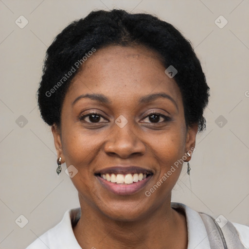 Joyful black young-adult female with short  black hair and brown eyes