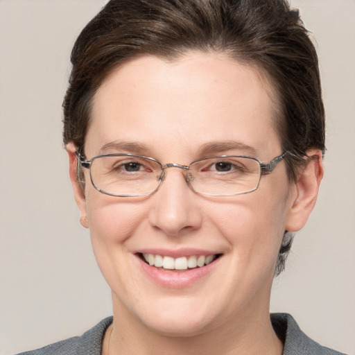 Joyful white adult female with short  brown hair and grey eyes