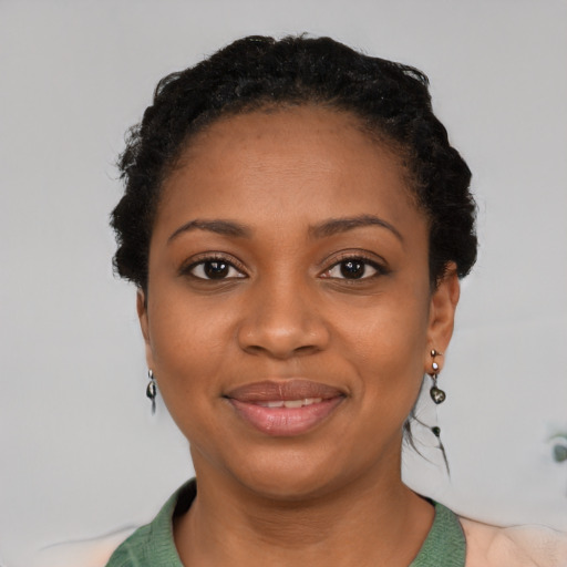 Joyful black young-adult female with short  black hair and brown eyes