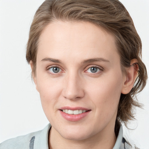 Joyful white young-adult female with medium  brown hair and blue eyes