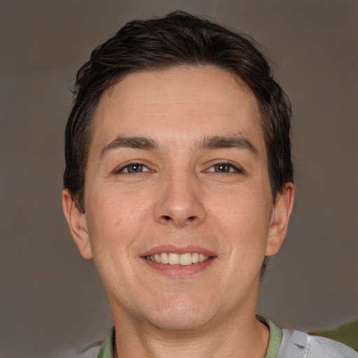 Joyful white adult male with short  brown hair and brown eyes