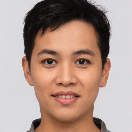 Joyful asian young-adult male with short  brown hair and brown eyes