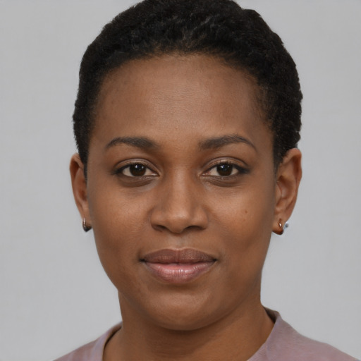 Joyful black young-adult female with short  black hair and brown eyes