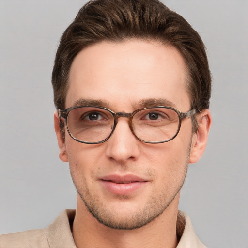 Joyful white young-adult male with short  brown hair and grey eyes