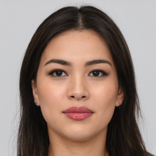 Neutral latino young-adult female with long  brown hair and brown eyes