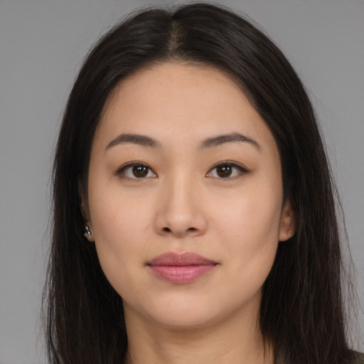 Joyful asian young-adult female with long  brown hair and brown eyes