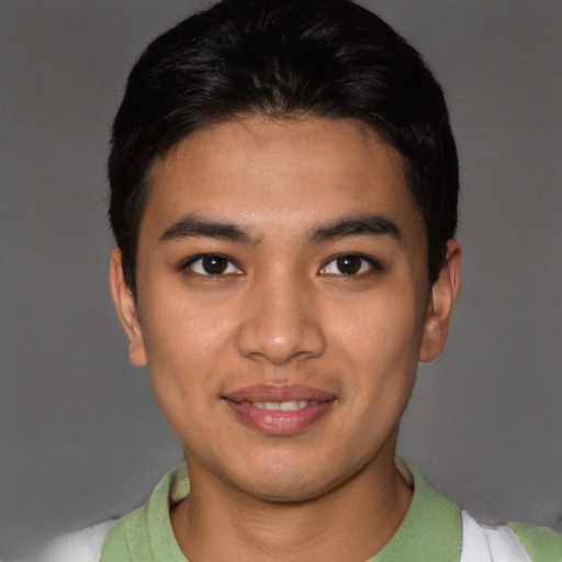 Joyful asian young-adult male with short  brown hair and brown eyes