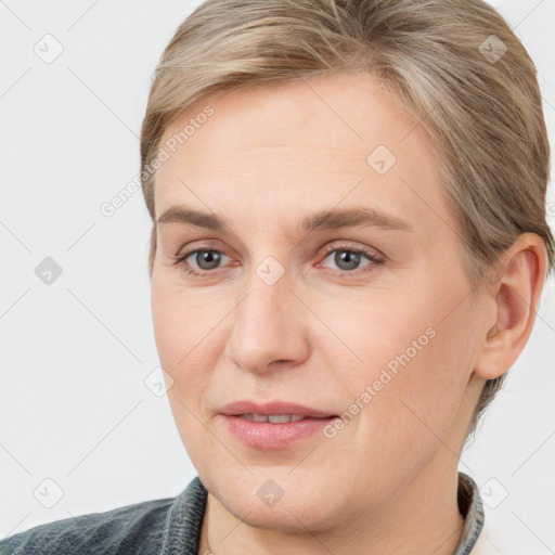 Joyful white young-adult female with medium  brown hair and blue eyes