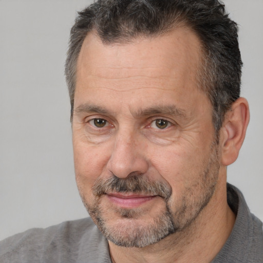 Joyful white middle-aged male with short  brown hair and brown eyes