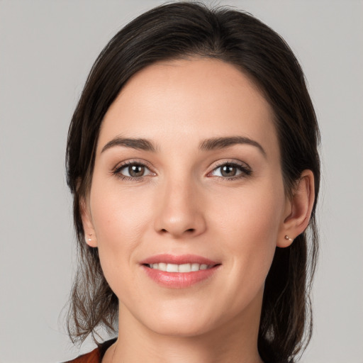 Joyful white young-adult female with medium  brown hair and brown eyes