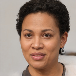 Joyful black adult female with short  brown hair and brown eyes