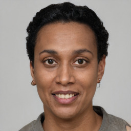 Joyful black adult female with short  black hair and brown eyes