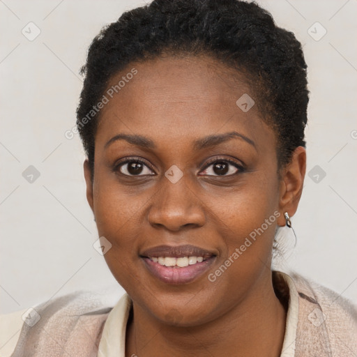 Joyful black young-adult female with short  brown hair and brown eyes