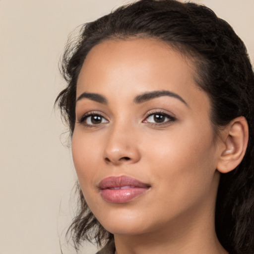 Joyful latino young-adult female with long  black hair and brown eyes