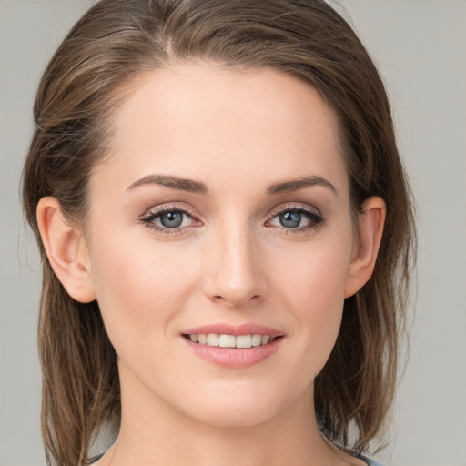 Joyful white young-adult female with medium  brown hair and grey eyes