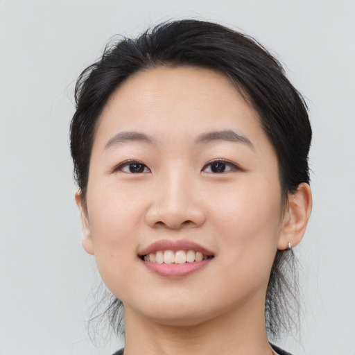 Joyful asian young-adult female with medium  black hair and brown eyes