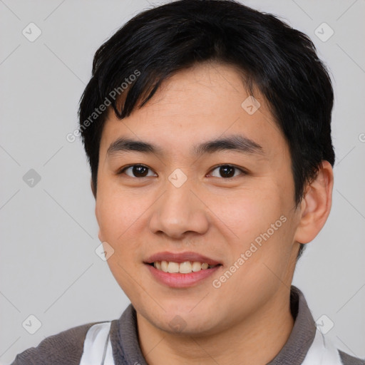 Joyful asian young-adult male with short  black hair and brown eyes