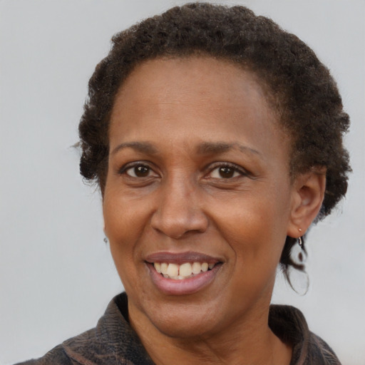 Joyful latino adult female with short  brown hair and brown eyes