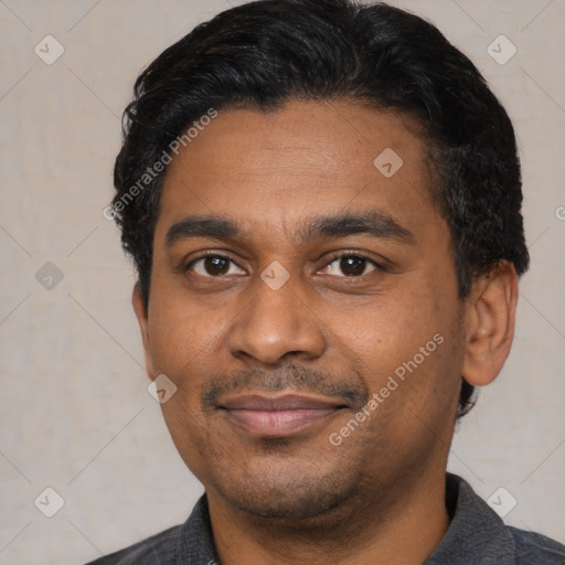 Joyful latino adult male with short  black hair and brown eyes