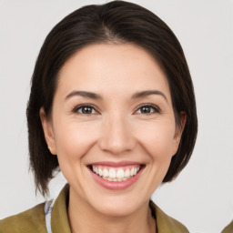 Joyful white young-adult female with medium  brown hair and brown eyes