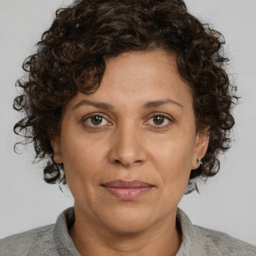 Joyful white adult female with short  brown hair and brown eyes