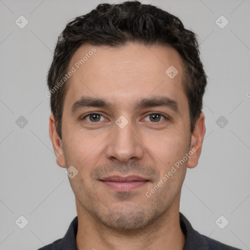 Joyful white young-adult male with short  black hair and brown eyes