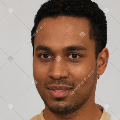 Joyful black young-adult male with short  black hair and brown eyes