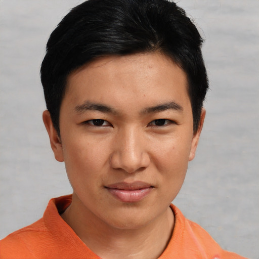 Joyful asian young-adult male with short  black hair and brown eyes