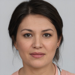 Joyful white young-adult female with medium  brown hair and brown eyes