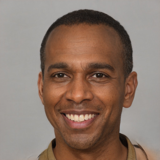 Joyful latino adult male with short  brown hair and brown eyes