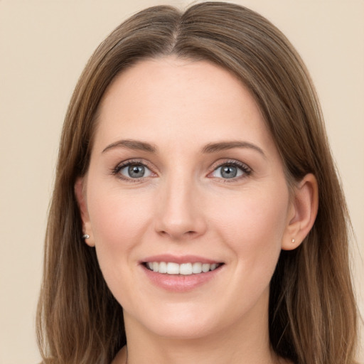 Joyful white young-adult female with long  brown hair and grey eyes