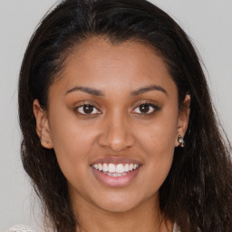 Joyful latino young-adult female with long  brown hair and brown eyes