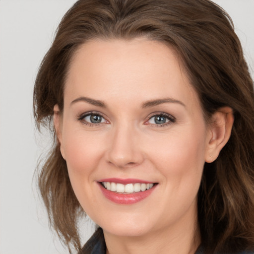 Joyful white young-adult female with long  brown hair and grey eyes