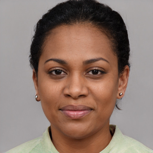 Joyful latino adult female with short  brown hair and brown eyes