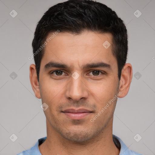 Joyful white young-adult male with short  black hair and brown eyes