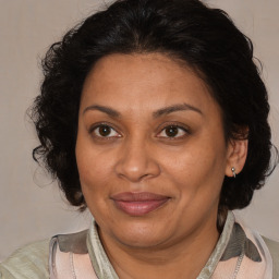 Joyful black adult female with medium  brown hair and brown eyes