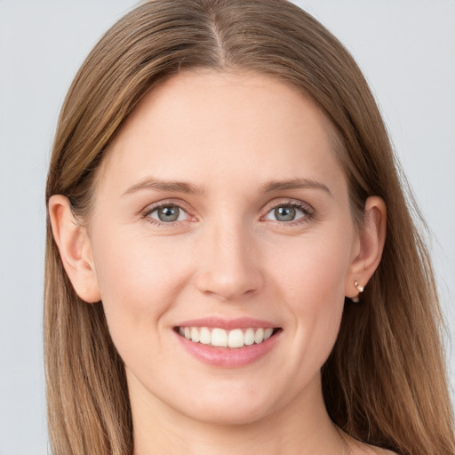 Joyful white young-adult female with long  brown hair and grey eyes