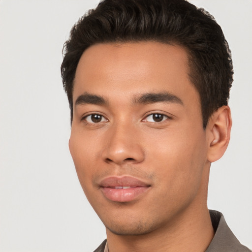 Joyful asian young-adult male with short  black hair and brown eyes