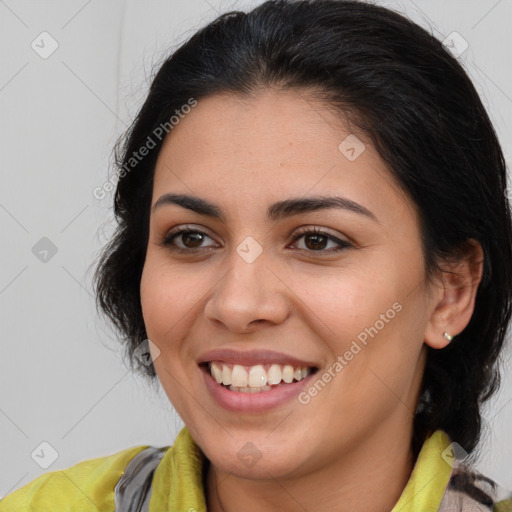 Joyful latino young-adult female with medium  brown hair and brown eyes