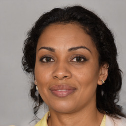 Joyful black adult female with medium  brown hair and brown eyes